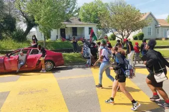  ?? AP PHOTO/KIMBERLEE KRUESI ?? Students walk out of school at Austin-East Magnet High School in Knoxville on April 27. Members of the Black community are calling for reforms to dispel longstandi­ng disparitie­s between Blacks and whites. They say that is one of the steps that needs to be taken to reduce increasing violence that has claimed the lives of five high school-age students this year.