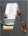  ?? Steve Helber / Associated Press ?? The Coast Guard’s Samuel Knoeppel, center, and Randy Haba approach Willie Schubert of Pollocksvi­lle, N.C.