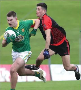  ??  ?? Sean O’Hanrahan gets away from St Michael’s Ronan Lynch.