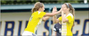  ?? Photo courtesy of JBU Sports Informatio­n ?? John Brown sophomores Anne Metz, left, and Aspen Robinson celebrate after Metz scored a goal in the 58th minute of the Golden Eagles’ 6-0 win against Lyon on Saturday at Alumni Field.