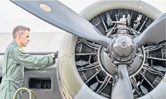  ??  ?? A mechanic prepares a Boeing B-17 Flying Fortress heavy bomber for display at this weekend’s Duxford Battle of Britain Air Show. The show, in Cambridges­hire, is the final official event for the centenary of the Royal Air Force, and offers a vision of the RAF’s innovative future capability.