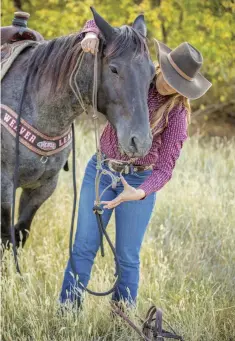  ??  ?? Never lead your horse by the reins; instead, use a trail halter, which correctly places pressure to cue him to lead and is already familiar to him.