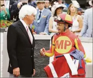  ?? Gregory Payan / Associated Press ?? The Kentucky Derby leads off the first Triple Crown season in decades without the chance of Bob Baffert, left, officially winning one or more of the three races. Baffert’s absence while suspended shadows over the race particular­ly because two horses he trained for a significan­t period of time are among the top contenders.