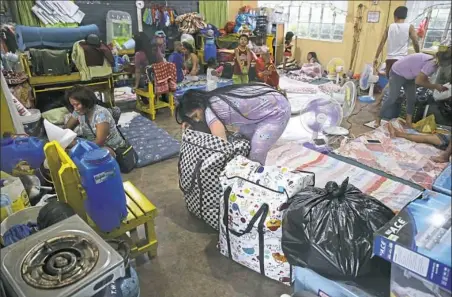  ?? Aaron Favila/Associated Press ?? An evacuee fixes her bag Friday inside a temporary evacuation center at Tuguegarao, Cagayan province, northeaste­rn Philippine­s.