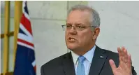  ?? GETTY IMAGES ?? Prime Minister Scott Morrison announces that clinical trials of a Covid-19 vaccine being developed by the University of Queensland will be abandoned.