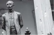  ?? ANDREW HARNIK AP ?? A bullet hole is visible in a statue of Cuban national hero Jose Marti and on a column in front of the Cuban Embassy on Thursday in Washington, D.C.