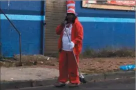  ?? L.A. PARKER - THE TRENTONIAN ?? Jackie Sherman dressed as “Cat in the Hat” during daily morning sweeping ritual on Walnut Avenue in Trenton.