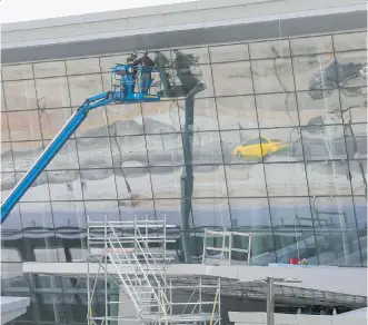  ?? LYLE ASPINALL ?? A new terminal stands under constructi­on at Calgary Internatio­nal Airport. The Calgary Airport Authority tried to quell concerns regarding noise levels at the airport at its annual general meeting Thursday.