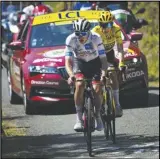  ?? Associated Press ?? Slovenia’s Tadej Pogačar, wearing the best young rider’s white jersey, tries to break away from Denmark’s Jonas Vingegaard, wearing the overall leader’s yellow jersey, in the 18th stage of the Tour de France, Thursday.