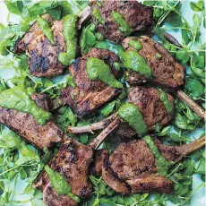  ??  ?? Nigella Lawson drizzles her Spicy Mint Lamb Chops with an herbaceous preserved lemon sauce.