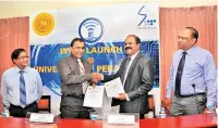  ??  ?? From left: Prof. Upul B. Dissanayak­e, Vice-chancellor of the University of Peradeniya and P. G. Kumarasing­he Sirisena, the Chairman of SLT Group exchanging the agreement. Prof. R.L. Wijeyeweer­a, Deputy Vice-chancellor of the University of Peradeniya...