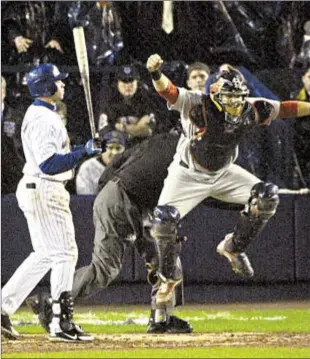  ??  ?? In lasting image Flushing faithful will never forget, Cardinals catcher Yadier Molina exults after Carlos Beltran strikes out looking against Adam Wainwright to end Game 7 of 2006 NLCS at Shea Stadium — the Mets’ last playoff game.