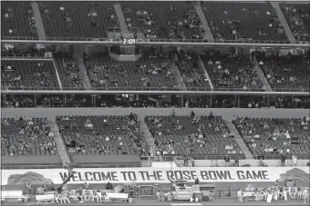  ?? ROGER STEINMAN/AP PHOTO ?? A banner at AT&T Stadium reads, “Welcome To The Rose Bowl Game”, as fans watch the teams warm up before the Rose Bowl game between Notre Dame and Alabama on Jan. 1 in Arlington, Texas.