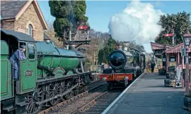  ?? JOHN TITLOW ?? The first trains of the day on April 15 cross at Hampton Loade: No. 2999 Lady of Legend runs in while No. 6960 Raveningha­m Hall waits for the token to Bridgnorth.