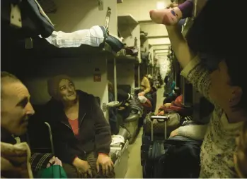  ?? CHRIS MCGRATH/GETTY ?? Civilians wait for a packed evacuation train to leave a railroad station Monday in Kherson, Ukraine.