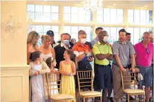  ?? SUSAN WALSH/ASSOCIATED PRESS ?? People stand behind chairs as they wait to watch President Donald Trump speak at the Trump National Golf Club in Bedminster, New Jersey on Saturday.