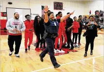  ??  ?? L.J. Williamson sees her son, Army Spec. Shakir Aquil, during Friday’s pep rally at Therrell High School. “It was unreal. I couldn’t believe it . ... And then I saw his uniform, and I lost it,” Williamson said.