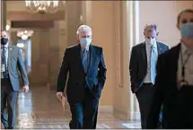  ?? J. SCOTT APPLEWHITE / AP ?? On the first full day of the new Democratic majority in the Senate, Sen. Mitch McConnell, R-Ky., the top Republican, walks to the chamber for the start of business as the minority leader at the Capitol in Washington Thursday.