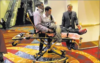  ?? Sam morris/ LAS VEGAS REVIEW-JOURNAL FILE ?? A man is wheeled out on a stretcher after the fight between Floyd Mayweather Jr. and Marcos Maidana at the MGM Grand Garden on Sept. 13. In a May bout between the two, 60 people were injured in a stampede.
