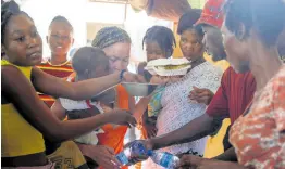  ?? AP ?? Women scuffle for plates of food for their children at a shelter for families displaced by gang violence, in Port-au-Prince, Haiti, on Friday, March 22.