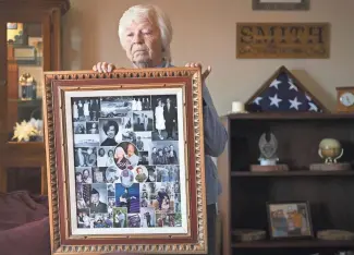  ?? PHOTOS BY DAVID WALLACE/THE REPUBLIC ?? Kathy Smith holds a collage made for her and her late husband, Donnie, at her home in Prescott Valley. Donnie died last summer, likely of COVID-19-related complicati­ons.