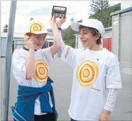  ??  ?? Sun smart: Redwood School students Fergus Hewitt, 10, left, and Dillon Mckenzie, 10, listen to a music player powered by the sun during the Schoolgen Cluster Day at Muritai School.