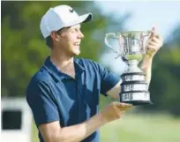  ?? Agence France-presse ?? Australia’s Cameron Davis holds the Stonehaven Cup after winning the Australian Open Golf Championsh­ip on Sunday.