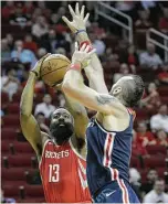  ?? Elizabeth Conley / Houston Chronicle ?? No obstacle was too big for James Harden, including Wizards center Marcin Gortat, as Harden finished with 38 points Tuesday night on 12-of-18 shooting from the field while going 9-of-10 on free throws.