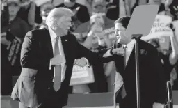  ?? MICHAEL CHOW/THE REPUBLIC ?? President Donald Trump elbow bumps Arizona Gov. Doug Ducey at a Make America Great Again Rally in Tucson on Oct. 19.