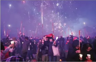  ?? JUNG YEON-JE/AFP ?? South Korean demonstrat­ors in Seoul on Saturday shoot off firecracke­rs to celebrate the impeachmen­t of Park Geun-hye during a candlelit rally demanding her arrest.