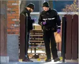  ?? HERALD PHOTO IAN MARTENS ?? Lethbridge police identifica­tion officers Rob Bittman and Steve Veale collect evidence at the scene of what police are calling a suspicious death Monday at a home on Lethbridge’s northside.