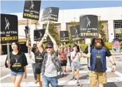  ?? RICHARD SHOTWELL INVISION/AP ?? Picketers demonstrat­e outside Warner Bros. studios on Wednesday in Burbank.