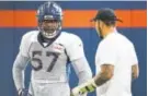  ?? John Leyba, Denver Post file ?? Rookie DeMarcus Walker (57) gets some pointers from Shane Ray.