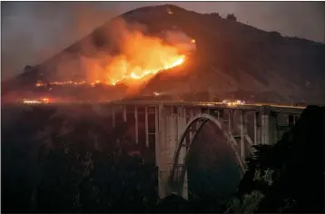  ?? KARL MONDON — STAFF PHOTOGRAPH­ER ?? The Colorado fire burns down toward the famed Bixby Bridge in Big Sur early Saturday morning.