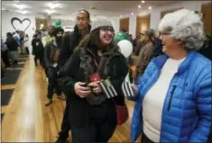  ?? THE ASSOCIATED PRESS ?? Margot Simpson, right, and Diana Gladden wait in line to purchase marijuana at Harborside marijuana dispensary Monday in Oakland, Calif. Starting New Year’s Day, recreation­al marijuana can be sold legally in California.