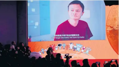  ?? AP ?? A screen shows footage of Alibaba Group co-founder Jack Ma during the Alibaba Group’s listing ceremony at the Hong Kong Stock Exchange in Hong Kong, Tuesday, November 26.