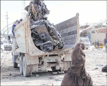  ?? Farah Abdi Warsame The Associated Press ?? A truck carries wreckage of a vehicle used in a bombing Saturday in Mogadishu, Somalia. At least 79 people were killed in the rush-hour explosion.