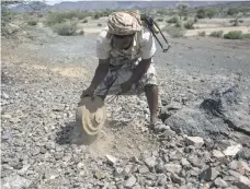  ?? Asmaa Waguih for The National ?? A member of the Saudi-backed Yemeni forces clears landmines planted by Houthis in Taez last month