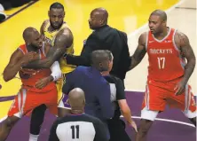  ?? Marcio Jose Sanchez / Associated Press ?? The Rockets’ Chris Paul (left) is held back by LeBron James of the Lakers during a fight late in Houston’s win Saturday night.