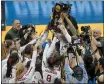  ?? KEITH SRAKOCIC — THE ASSOCIATED PRESS ?? The Stanford women’s volleyball team holds the championsh­ip trophy after defeating Wisconsin for the NCAA Division I women’s volleyball championsh­ip, Saturday in Pittsburgh.