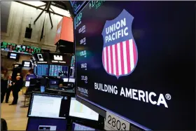  ?? (AP) ?? The Union Pacific logo appears above a trading post on the floor of the New York Stock Exchange in this 2019 photo. One of the railroad’s unions is threatenin­g a strike if the company doesn’t do more to protect employees from the coronaviru­s.