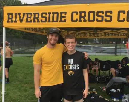  ?? NATE BARNES — THE NEWS-HERALD ?? Riverside senior Jack Condon, right, poses for a photo with his aide, Dustin Ettinger, after the Andrews Osborne Invitation­al on Oct. 6.