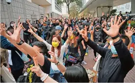  ?? (AFP) ?? Pro-democracy supporters protest outside the West Kowloon court, ahead of court appearance­s by dozens of dissidents charged with subversion, in Hong Kong on Monday