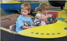  ?? PHOTO PROVIDED ?? Kids enjoy a carnival ride at a previous Summerfest, held annually by the Kiwanis Club of Sand Lake.