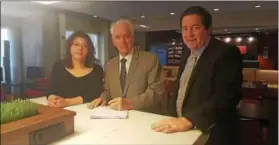  ?? COURTESY PHOTO ?? In this file photo, Donia Shawky, owner of Kangaroo Land Childcare Center in Valley Township, signs a lease with Jim DePetris, center, and Jack Corcoran of DEPG Associates to open a second location for her business in the city of Coatesvill­e. The...