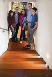  ??  ?? From left, Celia Cowles, 16, architect Brian Carlson, Katelena Hernandez Cowles, James Cowles and Gabriel Cowles, 14, pose for a photo in the Tarrytown home.