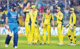  ?? PTI ?? Australian players celebrate the fall of Virat Kohli during the fourth ODI in Bangalore on Thursday.