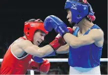  ?? JAE C. HONG/THE ASSOCIATED PRESS ?? Canada’s Mandy Bujold, left, fights China’s Cancan Ren during their quarter-finals match on Tuesday.