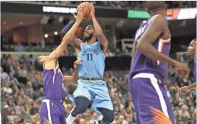  ?? COMMERCIAL APPEAL ?? Memphis Grizzlies guard Mike Conley shoots over Phoenix Suns guard Elie Okobo during their game at FedExForum on Saturday, Oct. 27, 2018. JOE RONDONE/THE