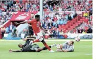  ?? Picture: CATHERINE IVILL/ GETTY IMAGES ?? THRILLING VICTORY: Taiwo Awoniyi of Nottingham Forest scores past Aaron Ramsdale of Arsenal during the Premier League match at the City Ground in Nottingham on Saturday